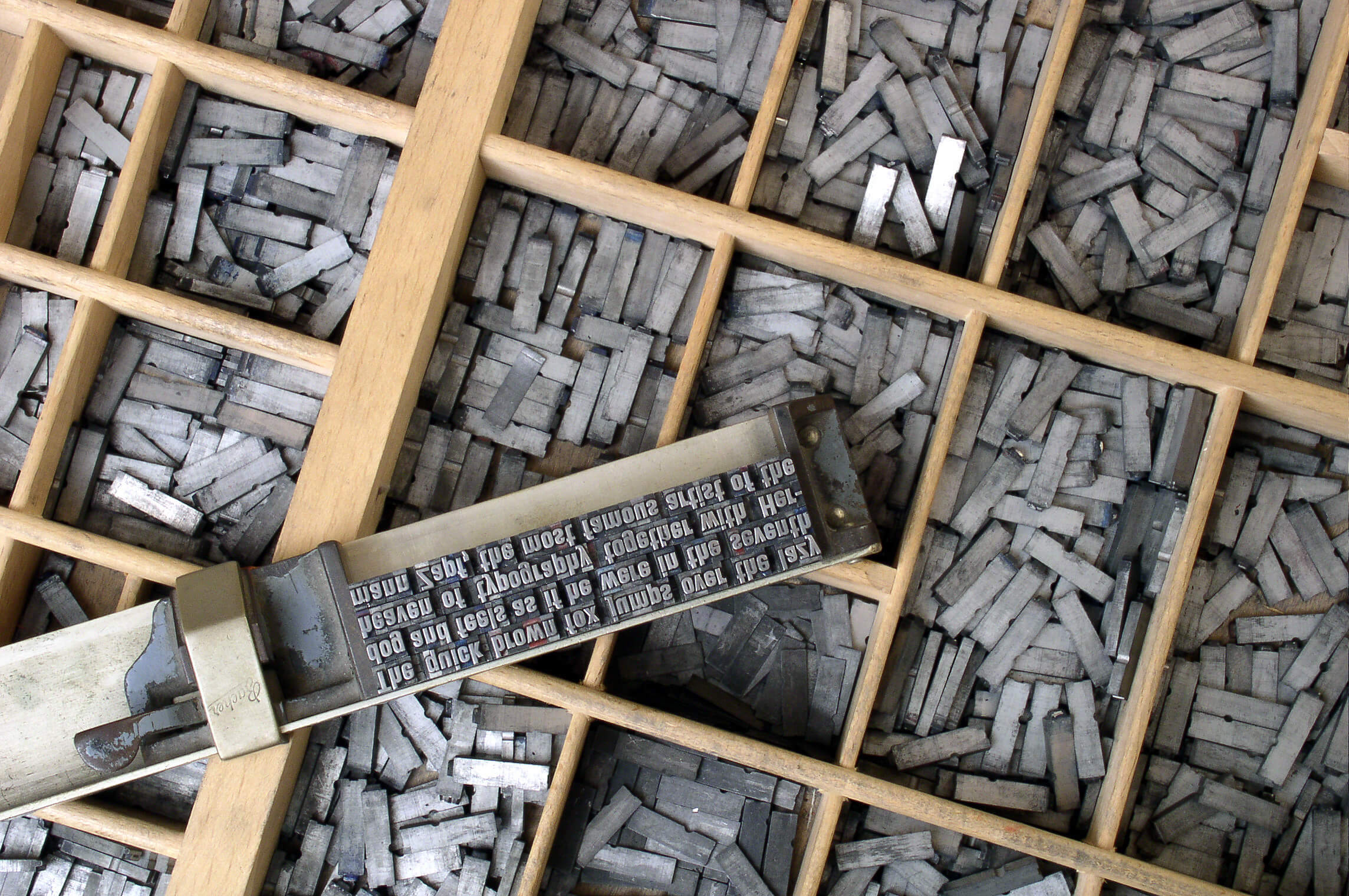 Movable metal type, and composing stick, descended from Gutenberg&rsquo;s press. Photo by Willi Heidelbach. Licensed under CC BY 2.5